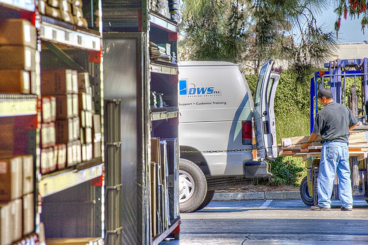 Person Standing Near Warehouse